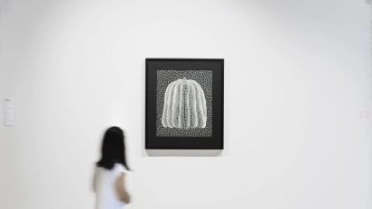 Visitor looking at Kusama's iconic pumpkin artwork.