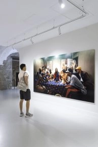 Visitor observing Jesus is my Homeboy: The Last Supper by LaChapelle, featuring modern figures in streetwear around a table inspired by the Last Supper. Visitor observing Jesus is my Homeboy: The Last Supper by LaChapelle, featuring modern figures in streetwear around a table inspired by the Last Supper.