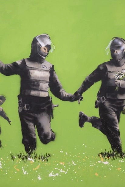 Banksy's Beanfield artwork with soldiers holding flowers on a green background at Moco Museum London
