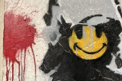 Banks's Smiling Copper of riot police with yellow smiley face, graffiti style on wall at Moco Museum Amsterdam.