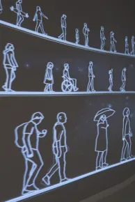 Digital artwork by Les Fantômes with figures walking continuously at Moco Barcelona.