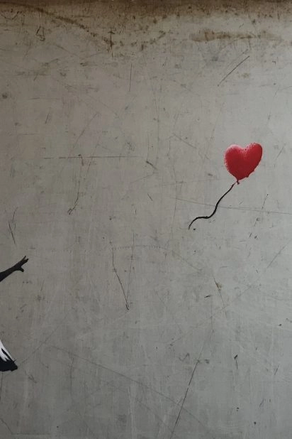 Banksy’s iconic “Girl With Balloon” artwork featuring a red heart-shaped balloon at Moco Museum Barcelona