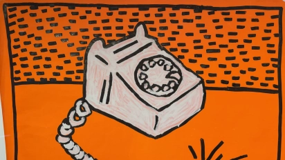 Keith Harings popart-schilderij van een telefoon op een feloranje achtergrond in Moco Museum Amsterdam.