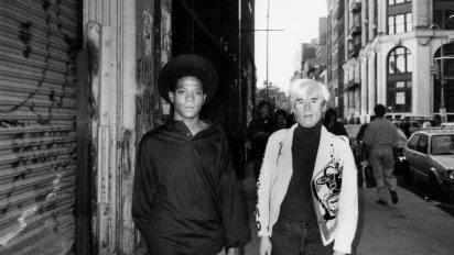 Black-and-white photo of Jean-Michel Basquiat and Andy Warhol.