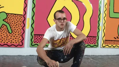 Keith Haring picture portrait in front of his artwork