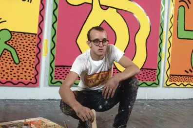 Keith Haring picture portrait in front of his artwork