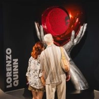 Visiteurs regardant sculpture en ballon métallique avec cœur rouge de Lorenzo Quinn au Moco Museum London