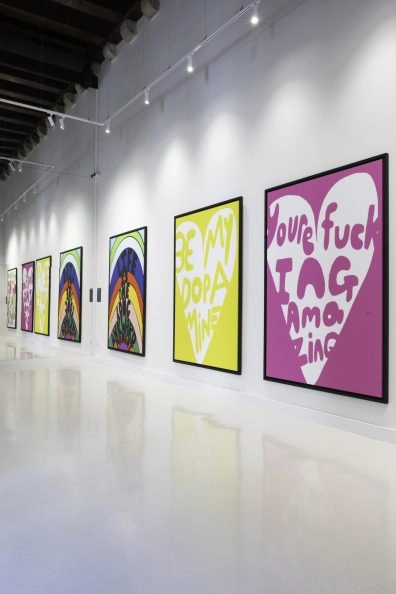 Gallery wall featuring bold text artworks by Robbie Williams, including “You’re fucking amazing,” at Moco Museum Barcelona. Gallery wall featuring bold text artworks by Robbie Williams, including “You’re fucking amazing,” at Moco Museum Barcelona.