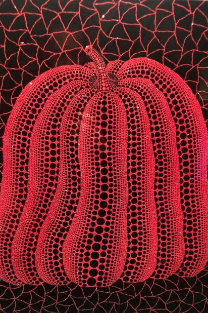 Yayoi Kusama red pumpkin sculpture with black net pattern