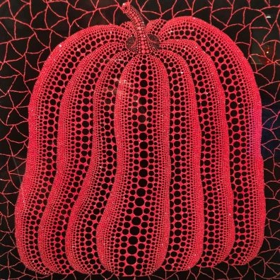 Yayoi Kusama red pumpkin sculpture with black net pattern