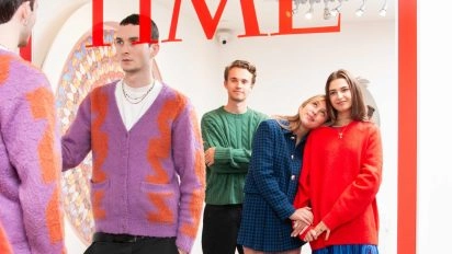 TIME magazine mirror artwork by Mungo Thomson with visitors posing at Moco Museum Amsterdam.