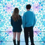 Visitors admiring vibrant floral digital room at Moco Museum Amsterdam. Visitors admiring vibrant floral digital room at Moco Museum Amsterdam.