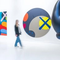 Colorful contemporary art and KAWS figure inside Moco Museum Barcelona.
