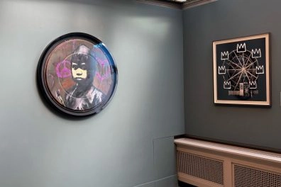Banksy's round and square artworks displayed in minimalist Moco Museum Amsterdam.