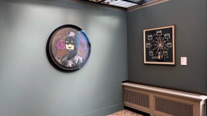 Banksy's round and square artworks displayed in minimalist Moco Museum Amsterdam.