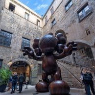 KAWS Companion statue in outdoor courtyard of Moco Museum Barcelona. KAWS Companion statue in outdoor courtyard of Moco Museum Barcelona.