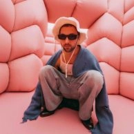 Andres Reisinger assis dans une pièce matelassée rose au musée Amsterdam. Andres Reisinger assis dans une pièce matelassée rose au musée Amsterdam.