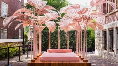 Pink outdoor art installation with umbrella-like structures at museum Amsterdam.
