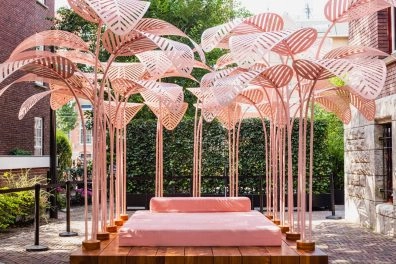 Pink outdoor art installation with umbrella-like structures at museum Amsterdam.